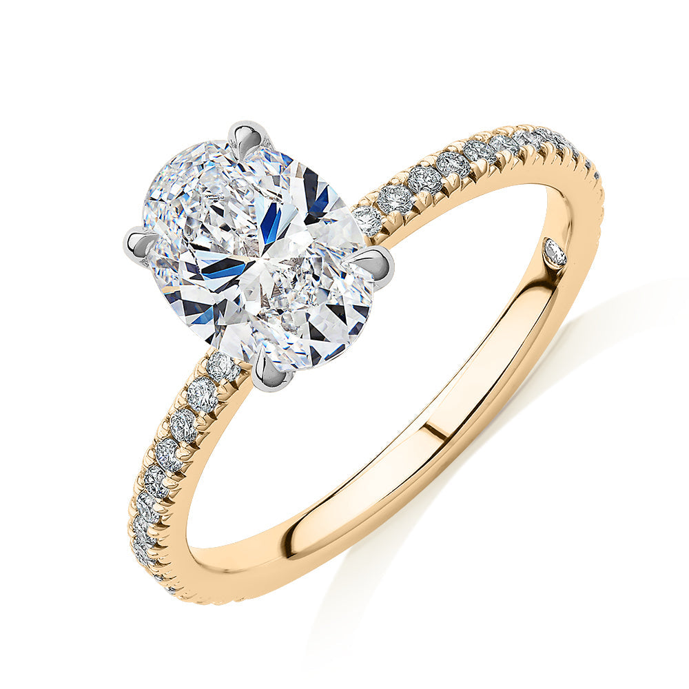 Signature Simulant Diamond 1.79 carat* TW oval cut shouldered engagement ring in 10 carat yellow and white gold