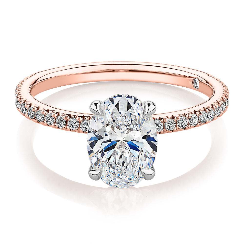 Signature Simulant Diamond 1.79 carat* TW oval cut shouldered engagement ring in 10 carat rose and white gold