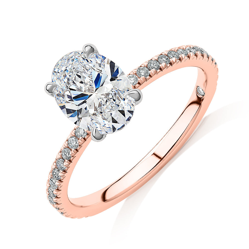 Signature Simulant Diamond 1.79 carat* TW oval cut shouldered engagement ring in 10 carat rose and white gold