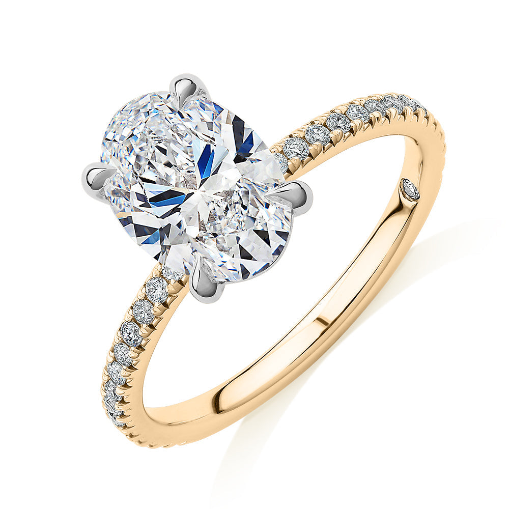 Signature Simulant Diamond 2.19 carat* TW oval cut shouldered engagement ring in 10 carat yellow and white gold