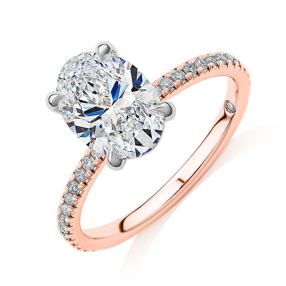 Signature Simulant Diamond 2.19 carat* TW oval cut shouldered engagement ring in 10 carat rose and white gold