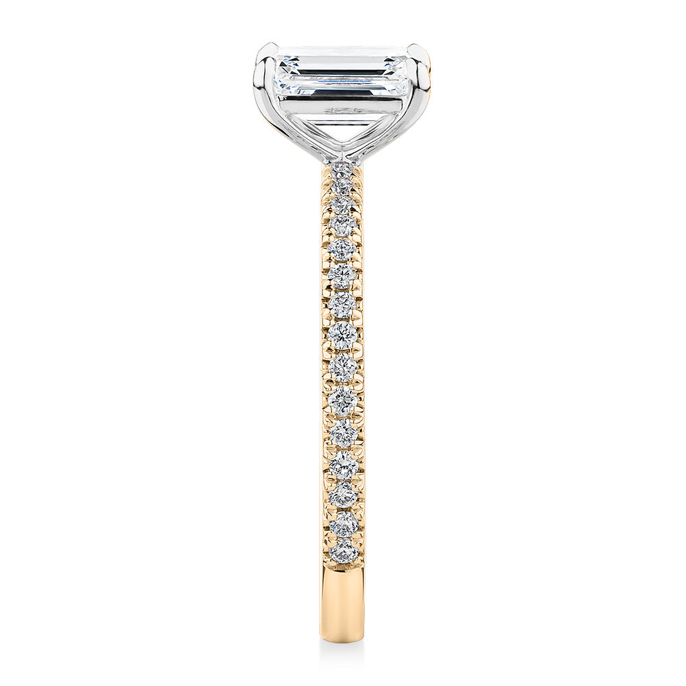 Signature Simulant Diamond 1.24 carat* TW emerald cut and round brilliant shouldered engagement ring in 10 carat yellow and white gold
