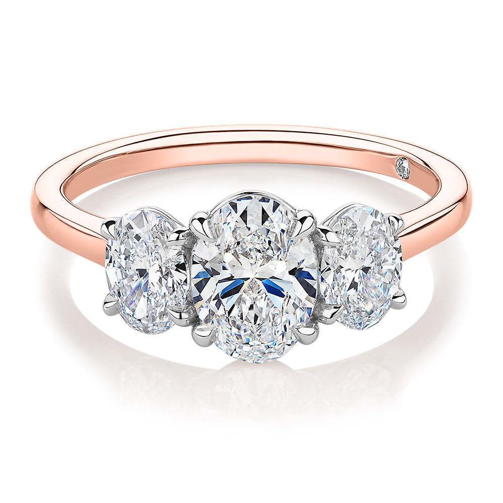 Signature Simulant Diamond 1.87 carat* TW oval three stone ring in 14 carat rose and white gold