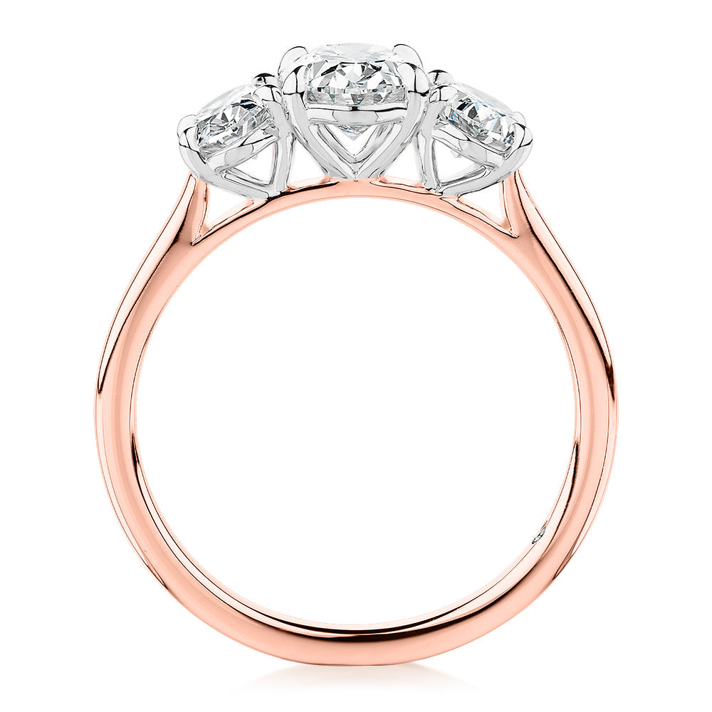Signature Simulant Diamond 1.87 carat* TW oval three stone ring in 14 carat rose and white gold