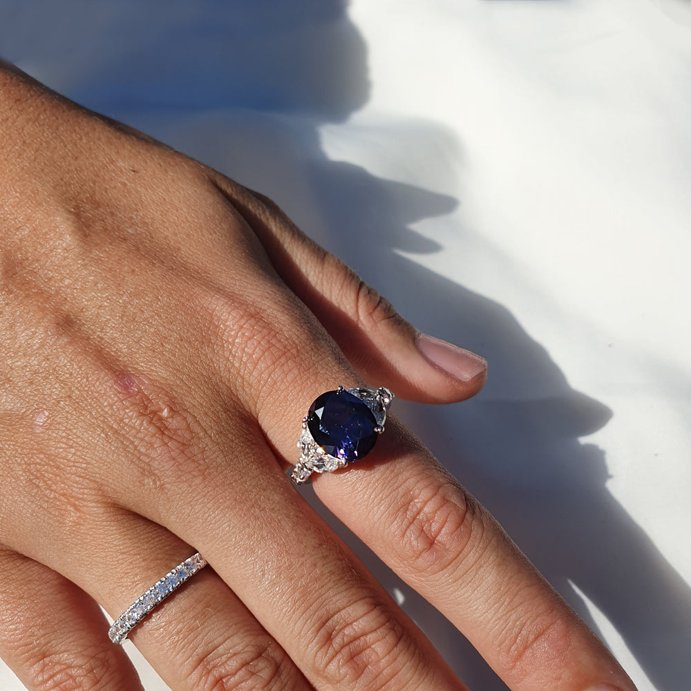 Dress ring with dark blue sapphire simulant and 1.45 carats* of diamond simulants in sterling silver